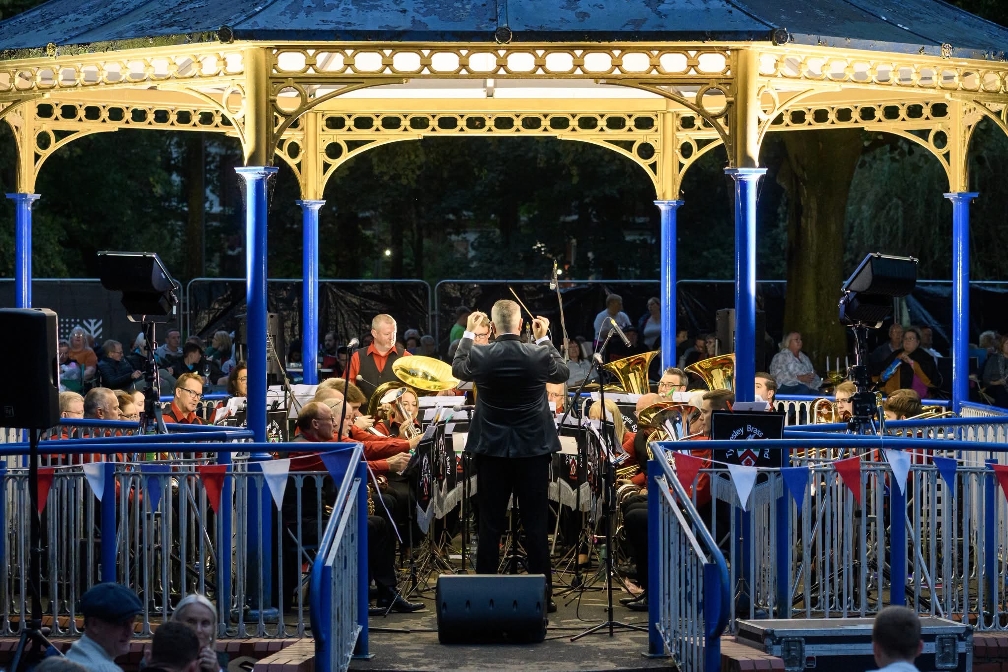 A band performs at night in one of the parks' bandstands